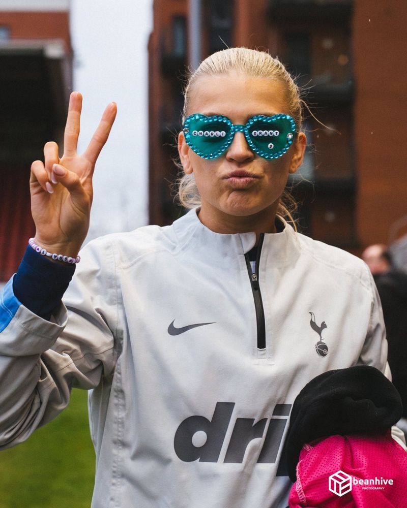Charli Grant of Tottenham Hotspur Women posing to the camera with heart shaped glasses on, doing the peace sign. 