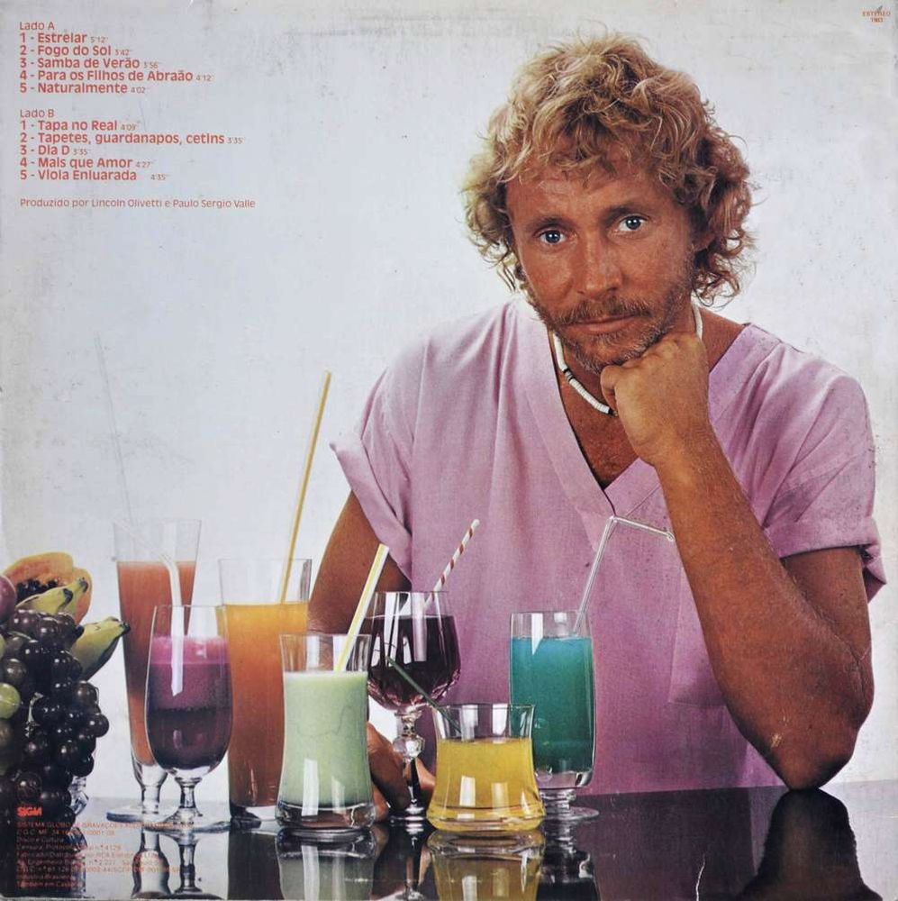 capa do album Estrelar de Marcos Valle apresentando um individuo loiro segurando um copo de suco azul e mais outros copos dos mais variados liquidos numa mesa. Texto: LADO A | 1 - Estrelar, 2 - Fogo do Sol, 3- Samba de VErão, 4 - Para os Filhos de Abraão, 5 - Naturalmente. Lado B | 1 - Tapa no Real, 2 - Tapetes, guardanapos, cetins, 3 - Dia D, 4 - Mais que Amor, 5 - Violea Enluarada