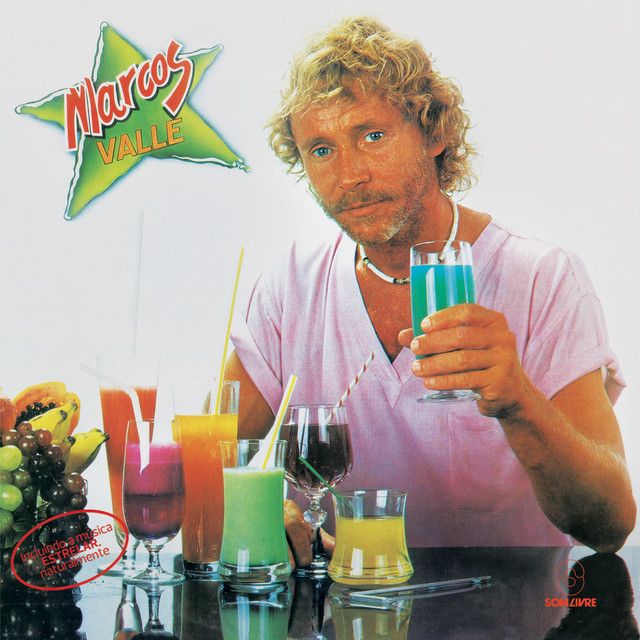 capa do album Estrelar de Marcos Valle apresentando um individuo loiro segurando um copo de suco azul e mais outros copos dos mais variados liquidos numa mesa. Texto: Marcos Valle