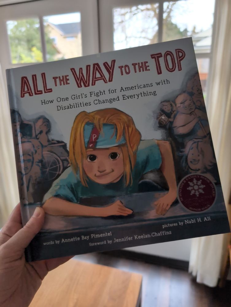 Photo is of the cover of a children's book called All The Way To The Top. How One Girl's Fight for Americans with Disabilities Changed Everything by Annette Bay Pimentel. 