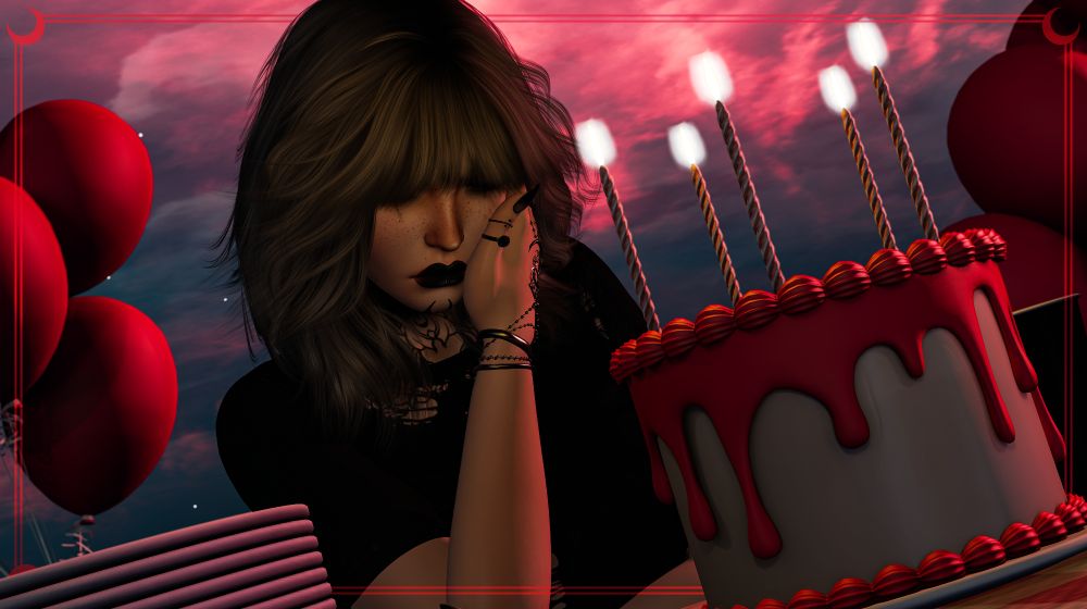 A person with silver hair, wearing dark runny makeup, jewelry, and a torn t-shirt sits behind a table decorated with birthday cake, plates and cups. They wipe tears from their face while balloons float behind them against a stark red sky.