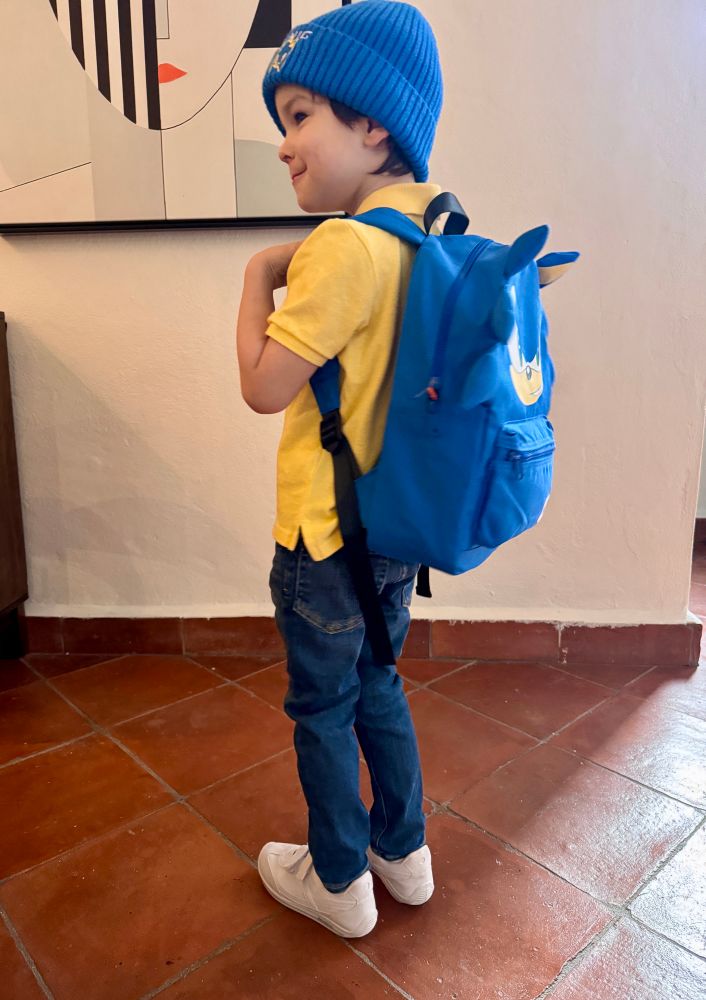 Same boy turned facing away from
The camera showing off his sonic backpack. 