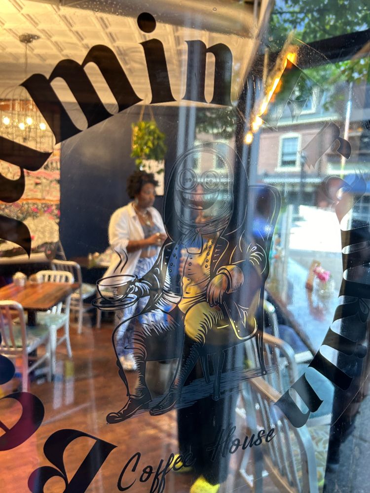 The window of a restaurant transformed into a coffee shop by putting a transparency over the window that reads "Beanjamin Franklin coffee house"