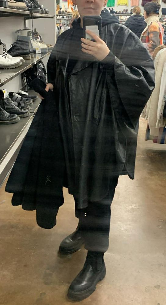 mirror photo of joe wearing an all leather poncho