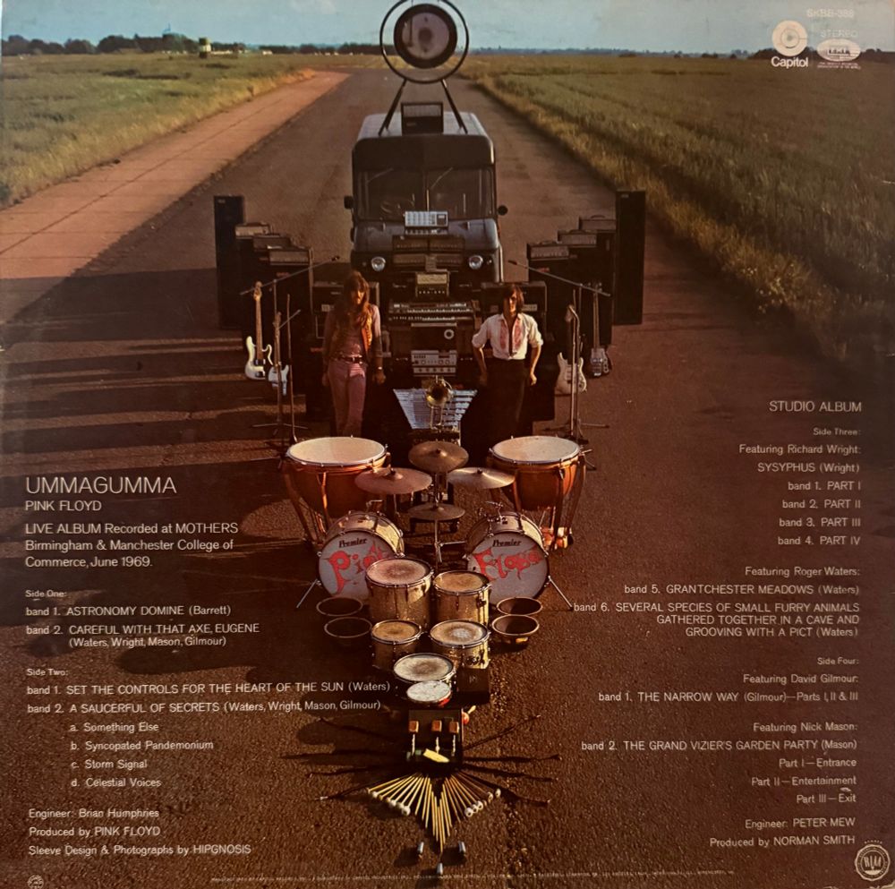 Back cover picture of band with all their equipment for the road including bus
Song list