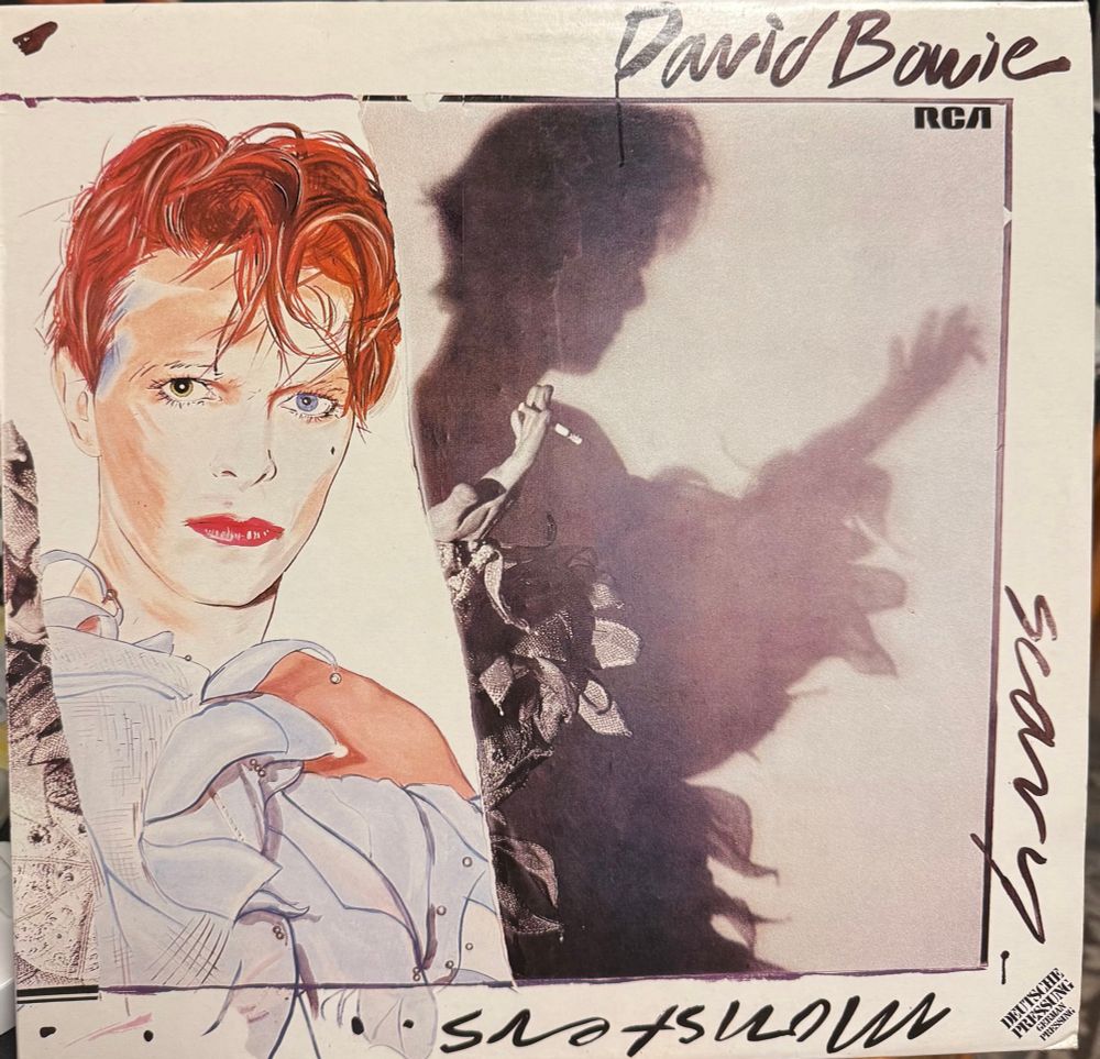 Front cover paining of bowie and silhouette of him playing guitar half of title