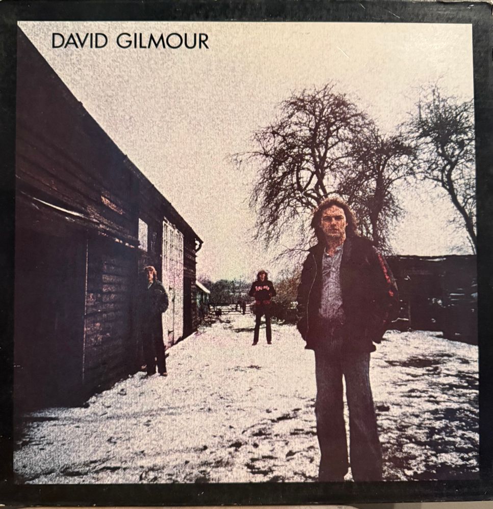 Front cover photo of gilmour and others 
Title upper left