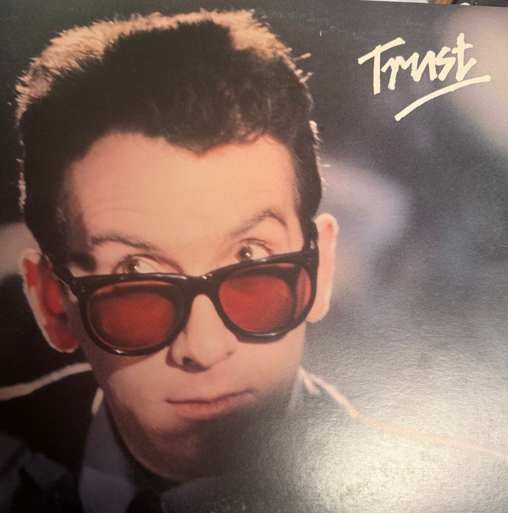 Front cover headshot of elvis sun glasses pulled down