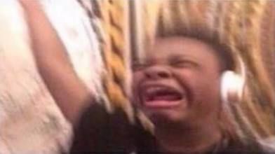 Meme of boy crying with headphones on and one arm raised