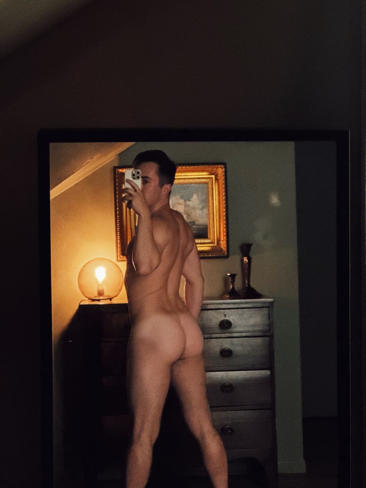 High contrast photo of nude man (me) with back facing the mirror/camera so you can see his ass and tan lines