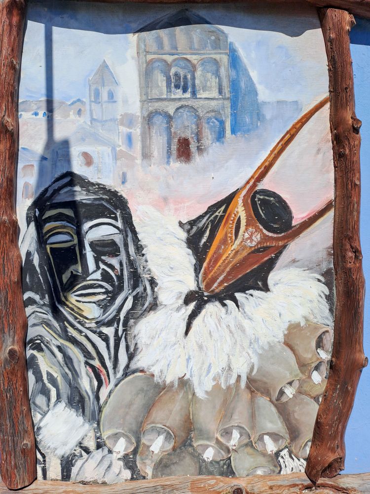 A painting depicting a Merdule (a guardian of the oxen) and a Boe (an ox), typical Sardinian masks which symbolize the struggle between human reason and animal instinct.