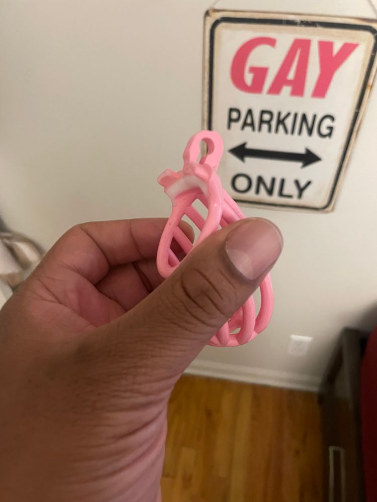 Pink chastity cage with one of the edges sanded down