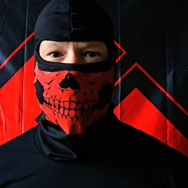 michael lee francis in a black balaclava with a red skull on it with just his eyes showing