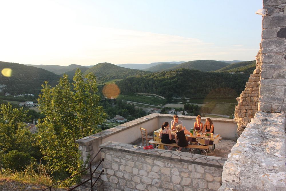 A view of some French archaeologists (and wonderful people) eating at a table on the terrace of a medieval monastery looking out over a valley in St Thome, Ardeche, France.