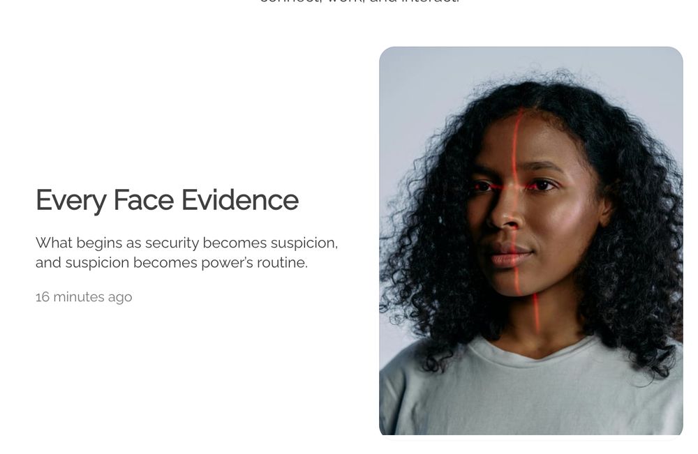 A Black person, head and shoulders in a gray sweater, slightly facing camera-left. Their face is being scanned by a red light. The background is light gray.