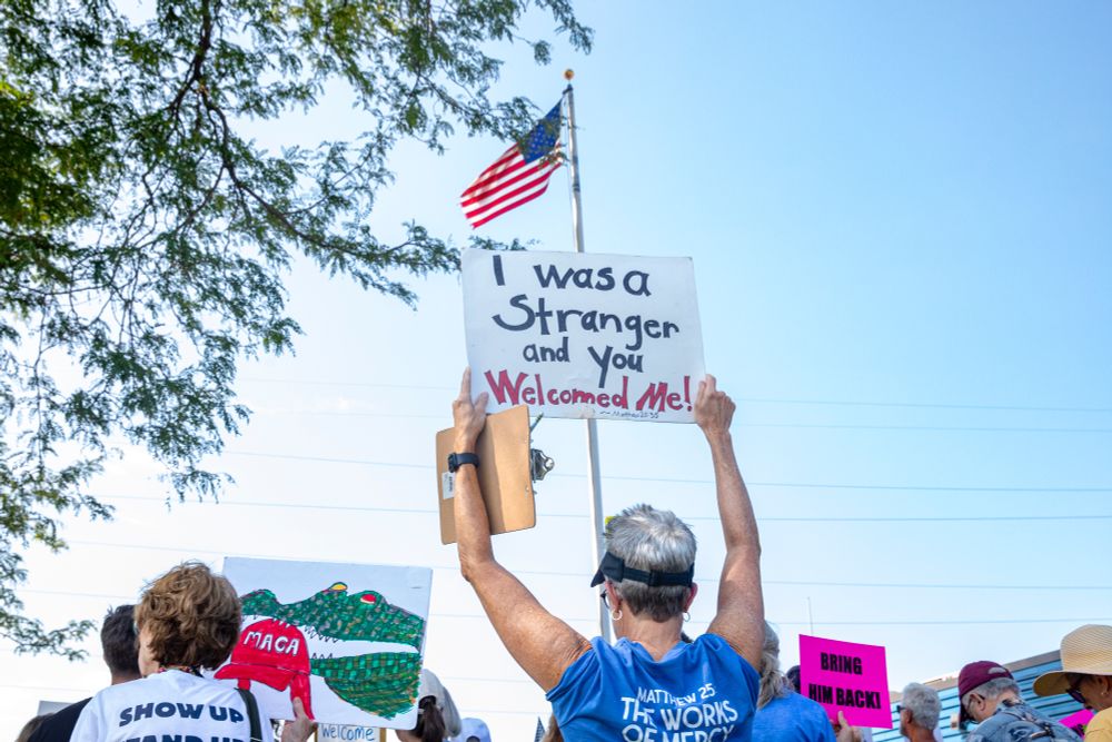 Community members hold signs during a demonstration in support of Pascual Pedro outside of the Department of Homeland Security’s office in Cedar Rapids, Iowa on Wednesday, July 9, 2025. Pedro, who had lived in Iowa for seven years after immigrating with his father at age 13, was deported to Guatemala less than a week after being detained at a required annual check-in. (Nick Rohlman/The Gazette)