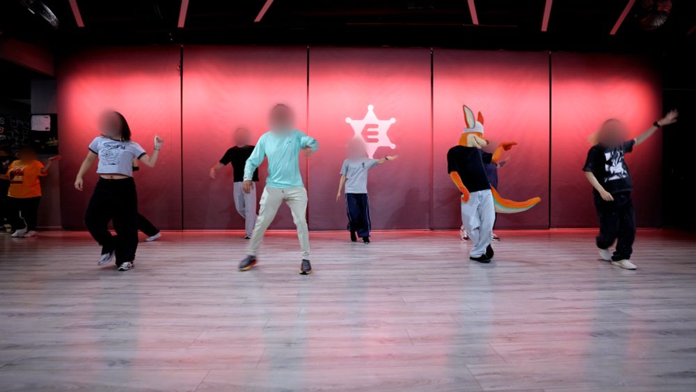 A picture of a dance studio with a few dancers on the floor, with my kangaroo fursona as one of them