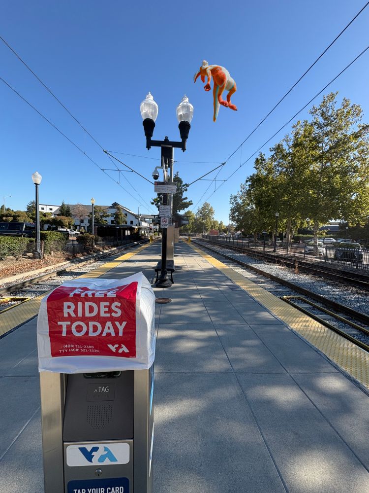 a picture of a vta light rail station with a floating kangaroo in the background
