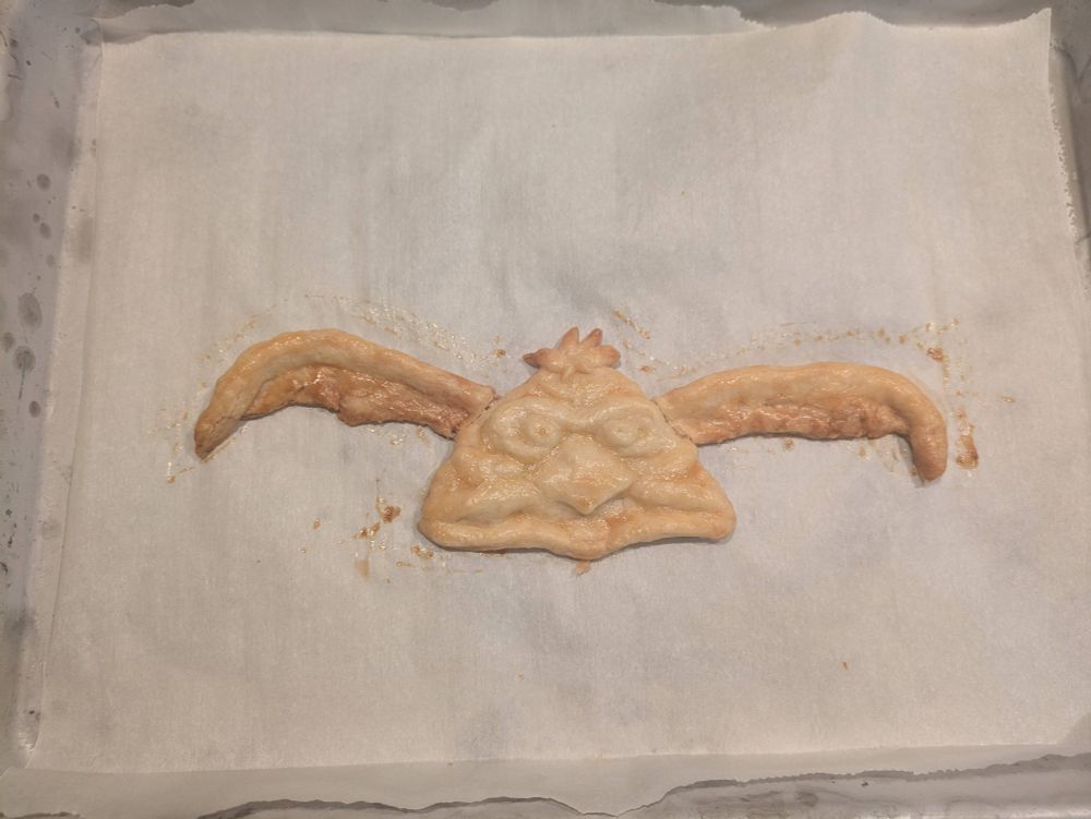 Baked pastry on parchment paper, pastry is shaped to look like Star Wars character Salacious B Crumb
