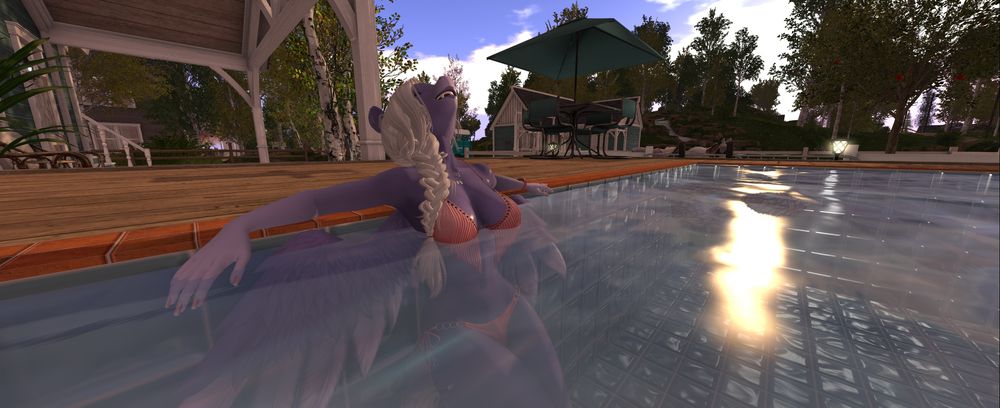 A screenshot from Second Life of an anthro pony pegasus in her backyard swimming pool leaning with her back against the pool's tiled side wall.