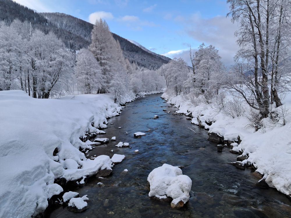 The upper Rhone atUlrichen banked by snow.