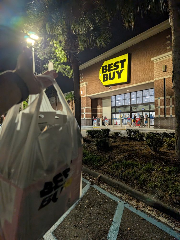 Picture of a nintendo switch 2 in a bag in front of a best buy