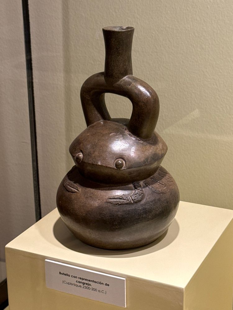 An adorable bottle in the shape of a crab with large, serious eyes.