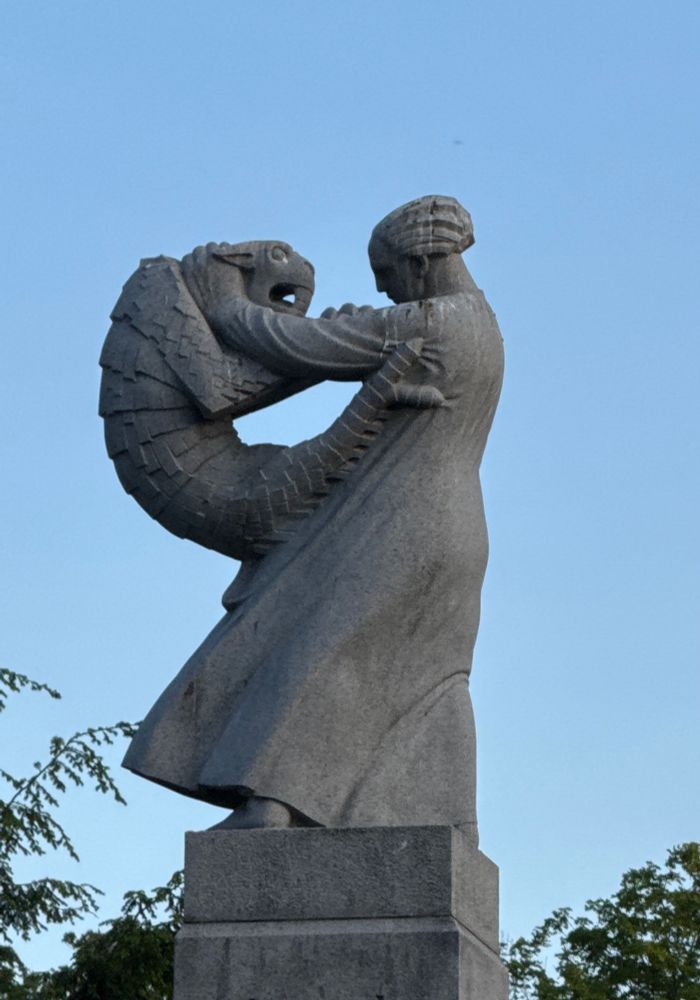 A woman in a gown holding a small fish-shrimp-thingy in an apparently loving embrace. Families are complicated.