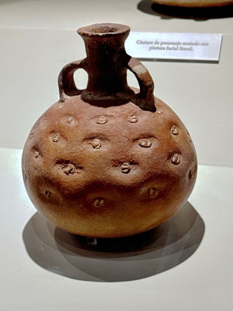 A vessel in the form of a potato with lovingly detailed eyes.