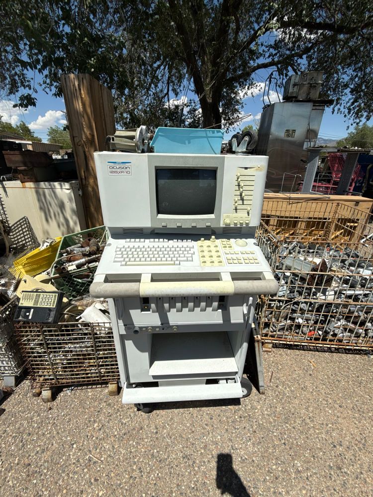 A medical machine of uncertain provenance amid crates of electronic detritus 