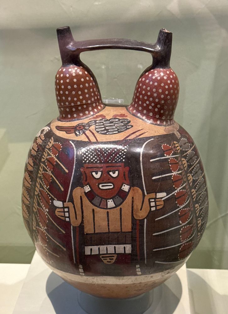 A vessel with a painted figure surrounded by fruits or grains, and an expression indicating that he has a fuckload of work to do and you are bothering him.