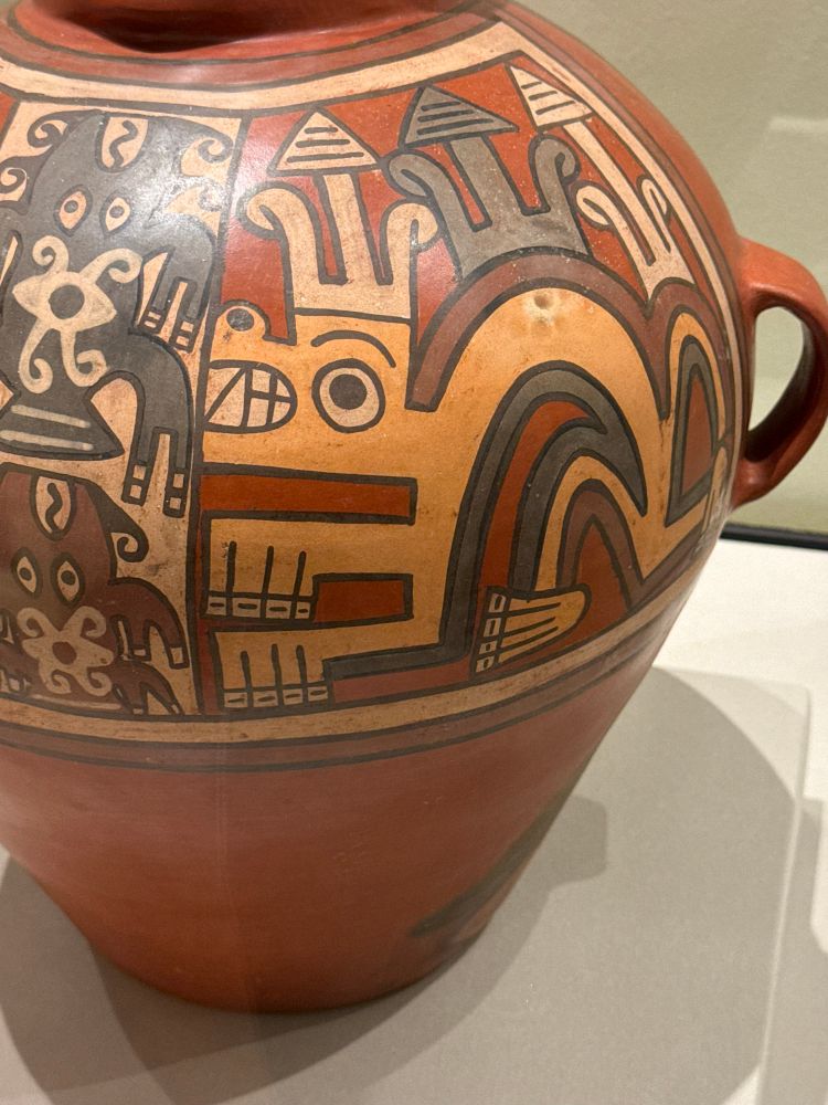 A crouched yellow beast on red clay pot