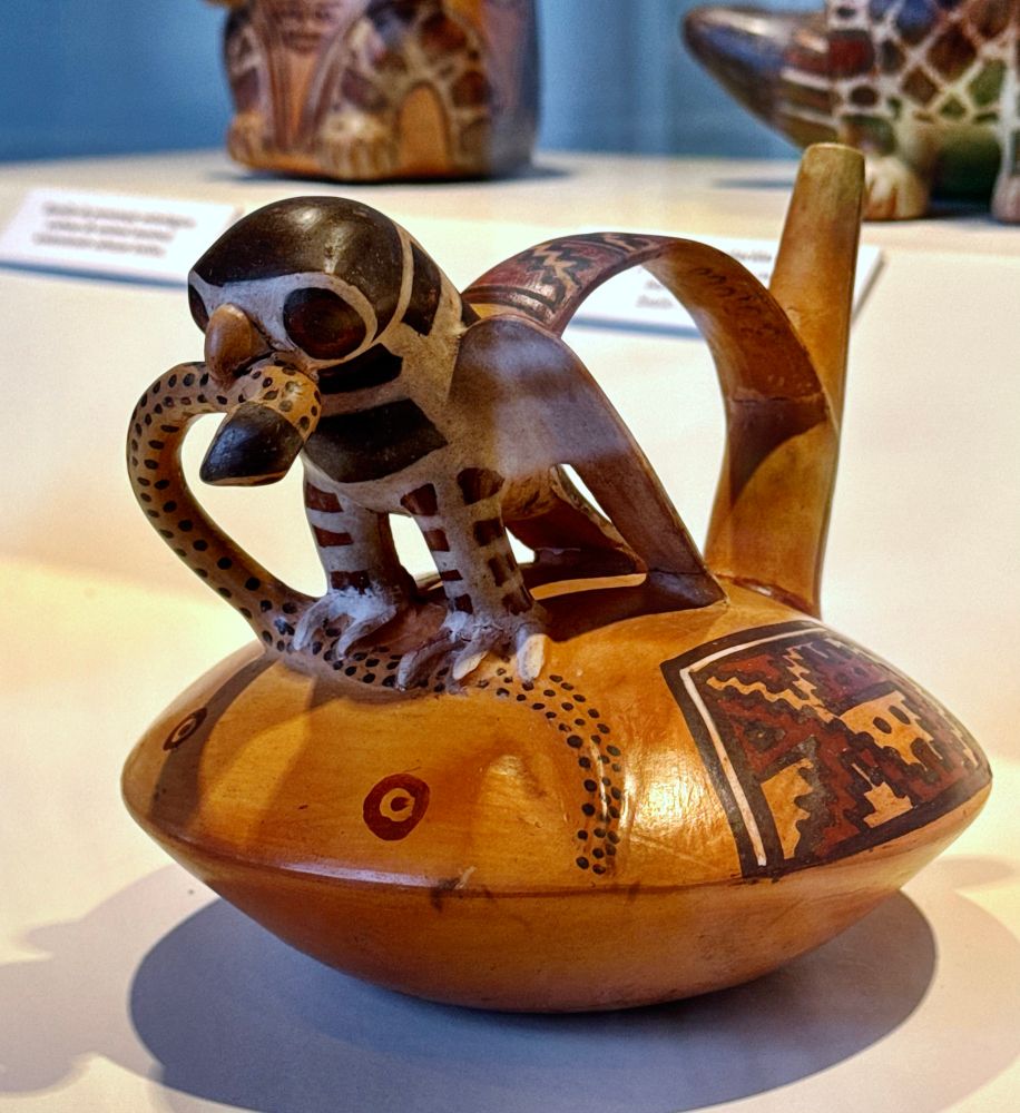 A clay vessel with an owl devouring a snake