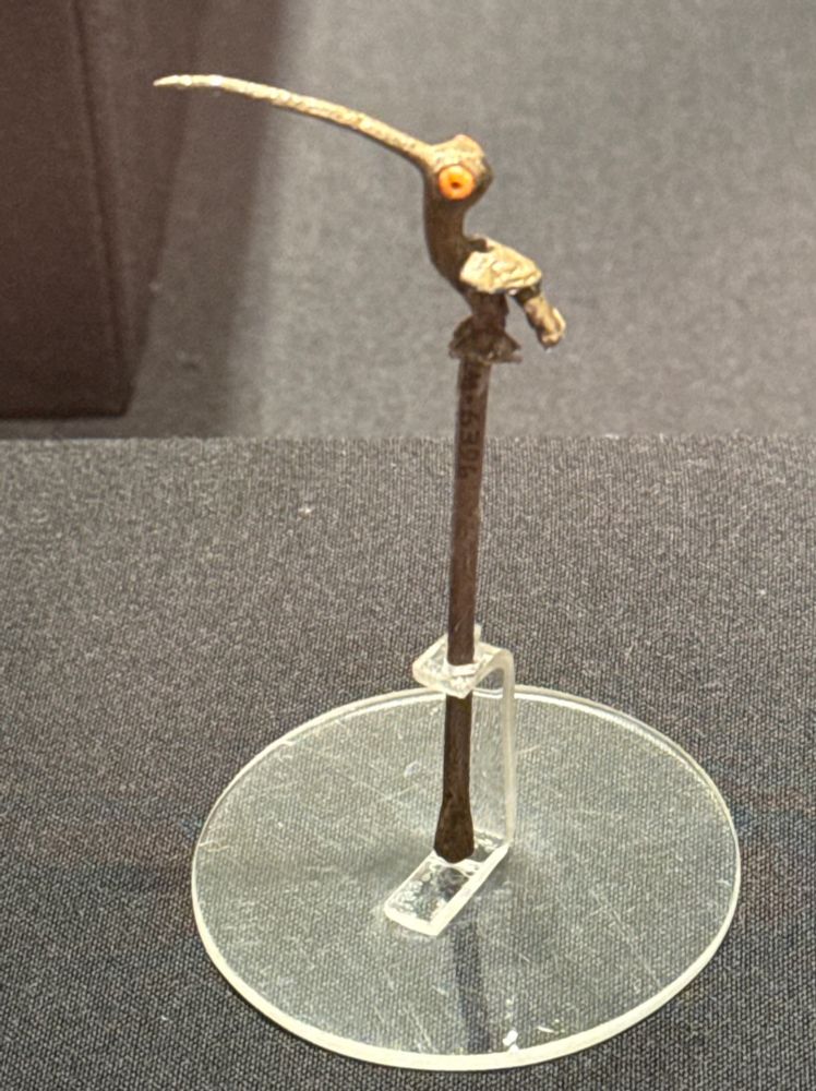 A small, adorable metal hummingbird on a stick.