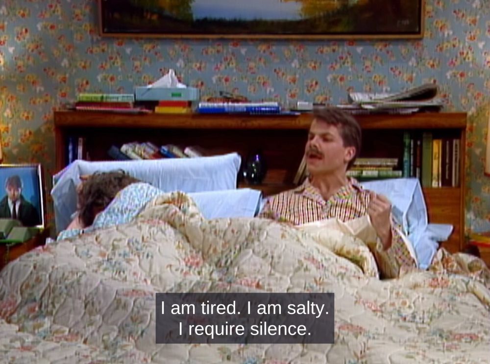 Character from Kids in the Hall in bed saying, "I am tired. I am salty. I require silence."