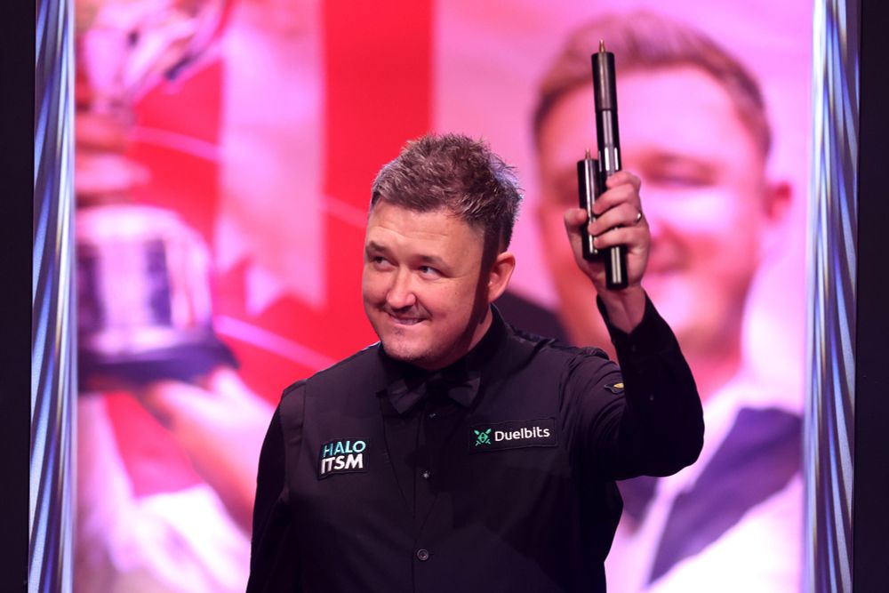 A smiling Kyren Wilson makes his entrance.