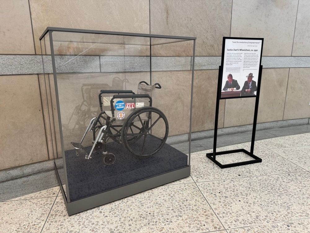 A wheelchair in a glass case