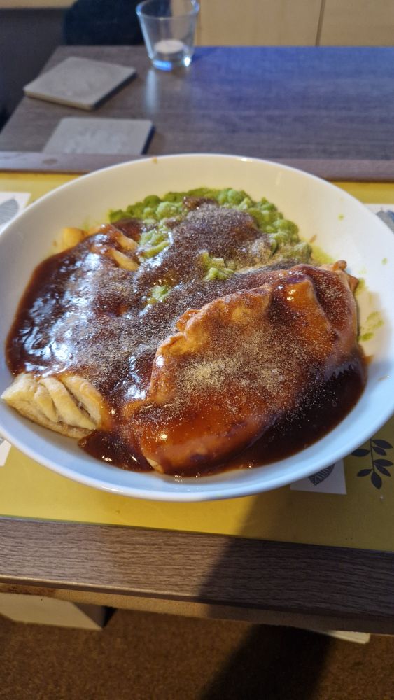 A cornish pasty and sausage roll with mushy peas and a decent amount of gravy.