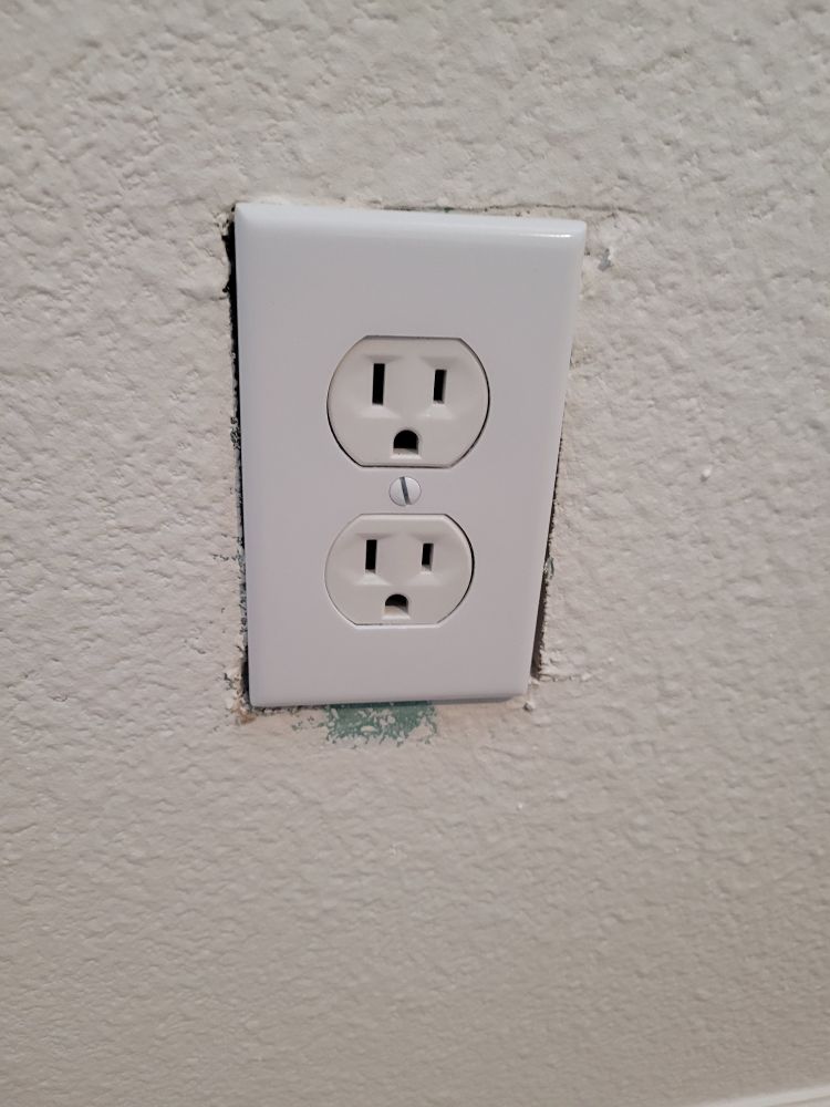 New drywall was installed here, cut too big for the outlet cover. 