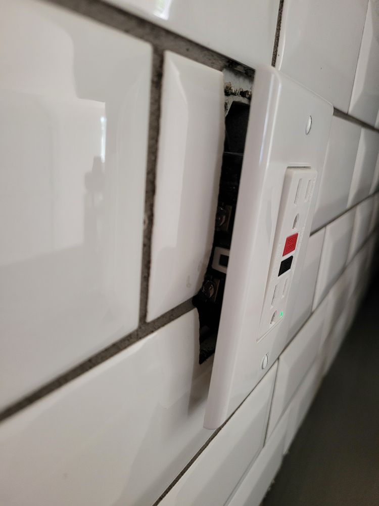 Electrical outlet not flush to tile. 
