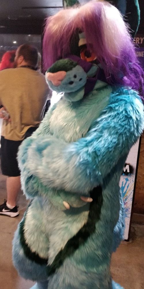A picture of J, a Green/Teal Jackal/Husky fursuiter