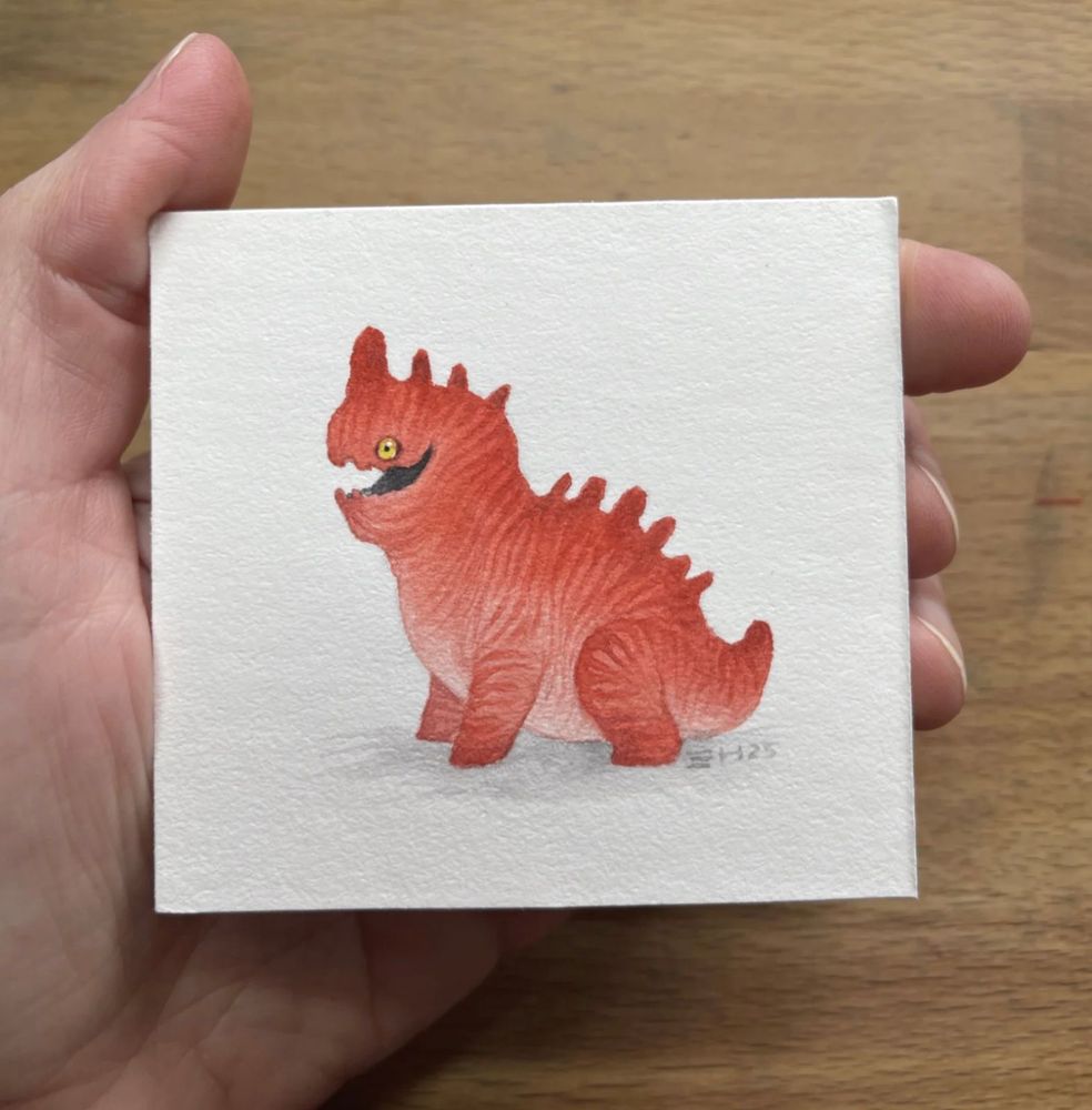 tiny chubby little red striped dragon with a yellow eye and a cheeky face