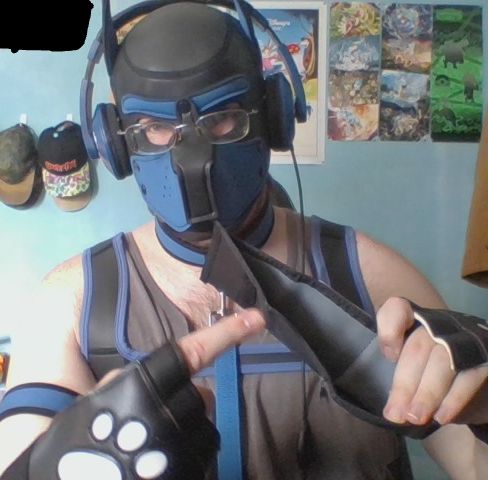 30 year old man in puppy play gear, gesturing to an empty wallet expectantly, as if expecting payment.