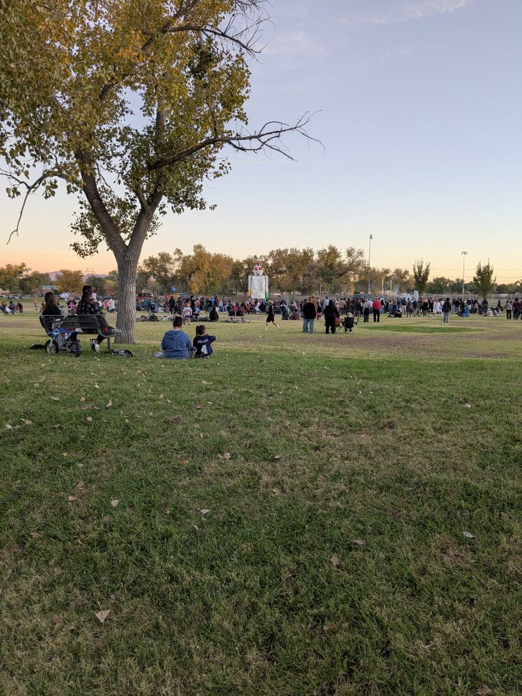 Field of people waiting to burn El Kookooee in the distance. Also a red Tesla, effigy I think.