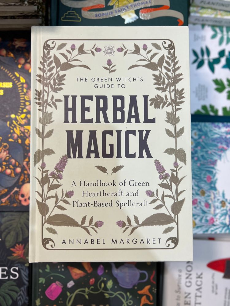 A book titled "herbal magick" by Annabel Margaret 