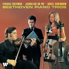 Cover of a 'Beethoven Piano Trios' disc by Pinchas Zukerman, Jacqueline du Pré and Daniel Barenboim. It is a photograph of the three artists against a dark orange background.