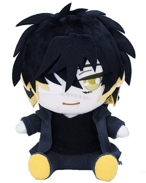 a stuffed animal with black hair and yellow eyes is sitting on a white surface