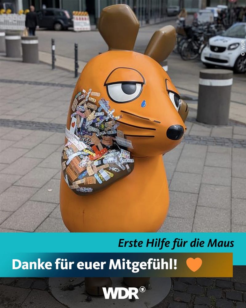 Die Maus vom WDR mit Pflastern und der Schrift „Danke für Euer Mitgefühl!🧡“