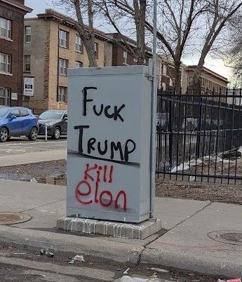 Graffiti on an public utility box on a sidewalk. On the top, in black, is "Fuck Trump." On the bottom, in red, is "Kill Elon." 