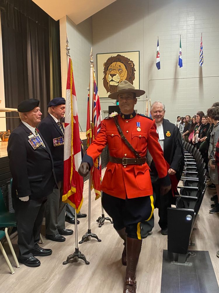 RCMP Insp. Tim Dell'Anna leads a procession into the front of the Adam Scott auditorium